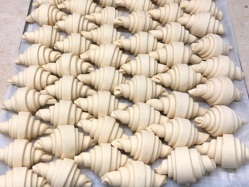 Rows of croissants rolled and waiting for the oven