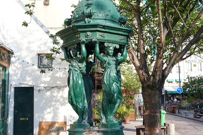One of Paris's green Wallace drinking fountains, four caryatids holding up its dome